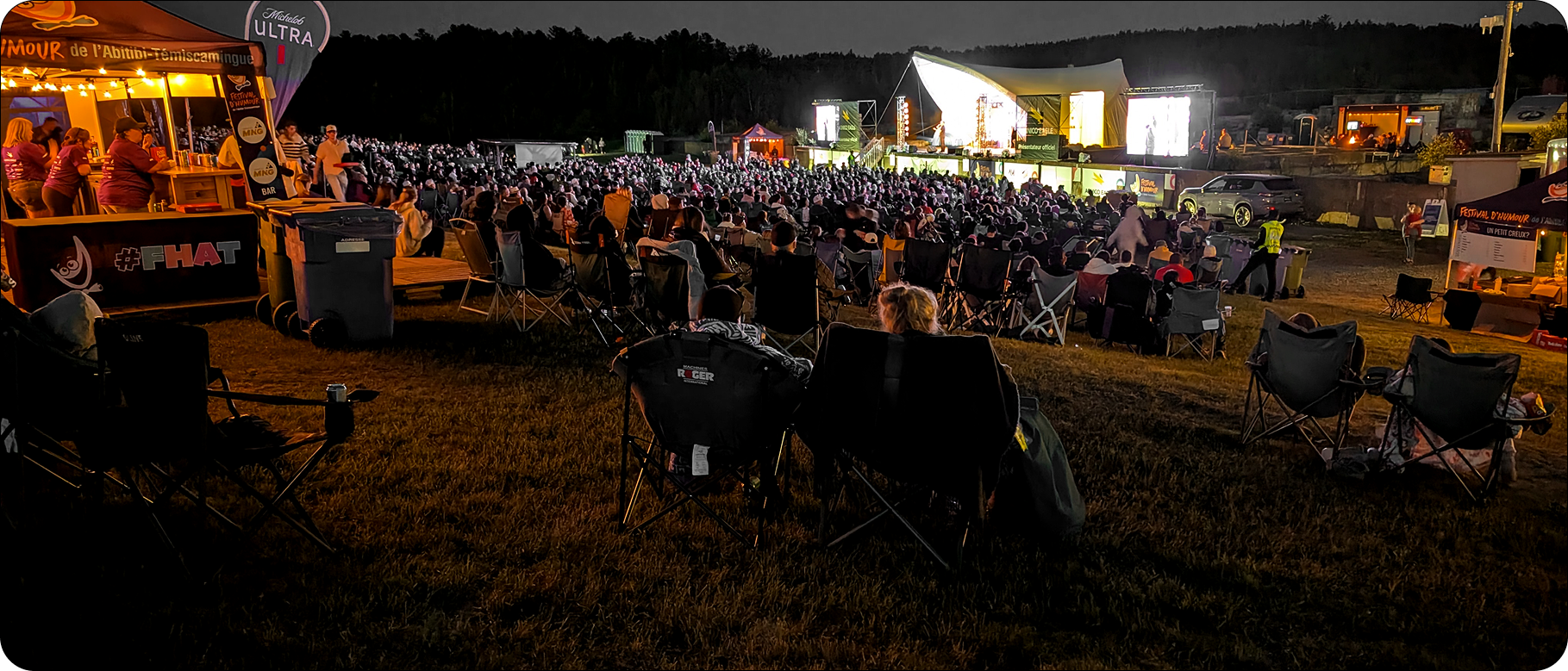 Audience seated facing the FHAT stage at night