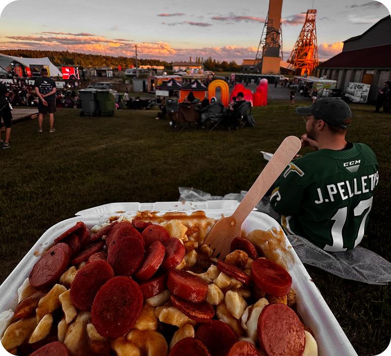 Poutine at the festival with the stage in the background